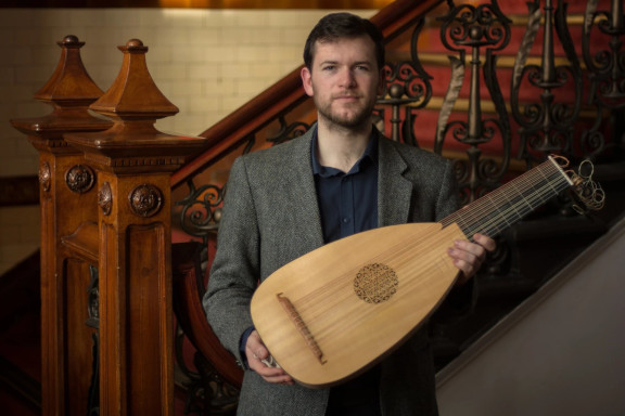 Alex McCartney holding a lute